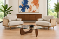 Fresh Sophia living-room image with a glass coffee table, black bowl, expressive art, and light oak floor