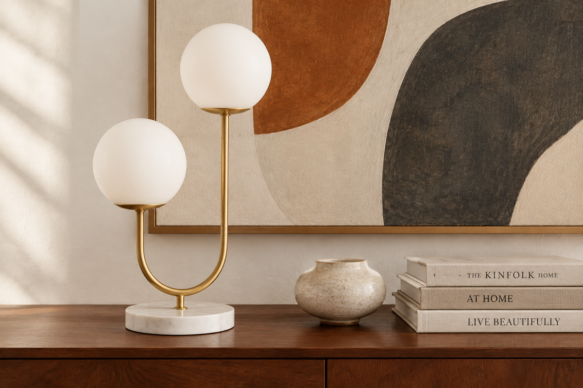 Halo Doppio lamp close-up on a walnut credenza with organic abstract art and ceramic accent
