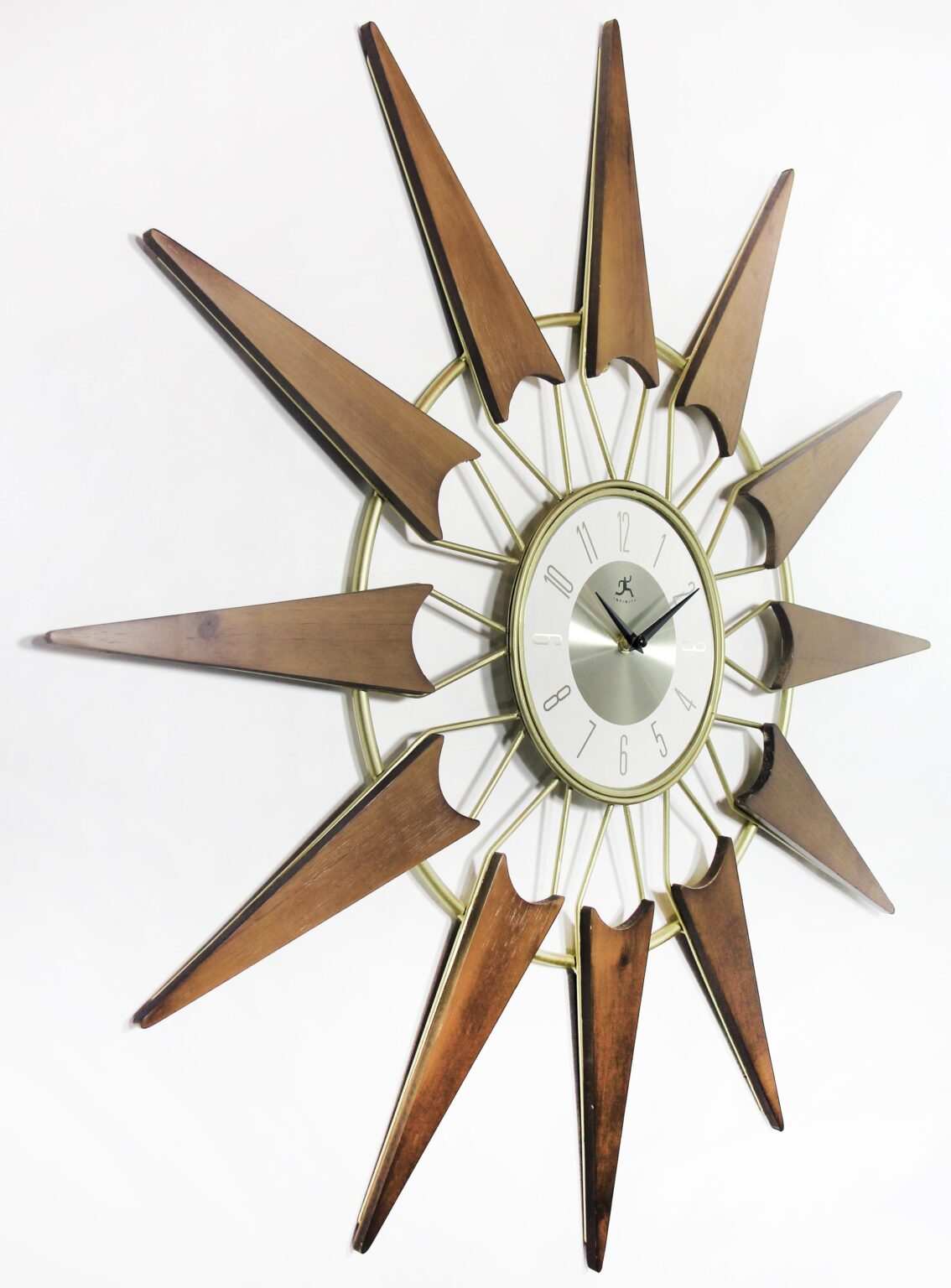 Nova starburst wall clock at an angle showing walnut-toned rays and brushed silver dial